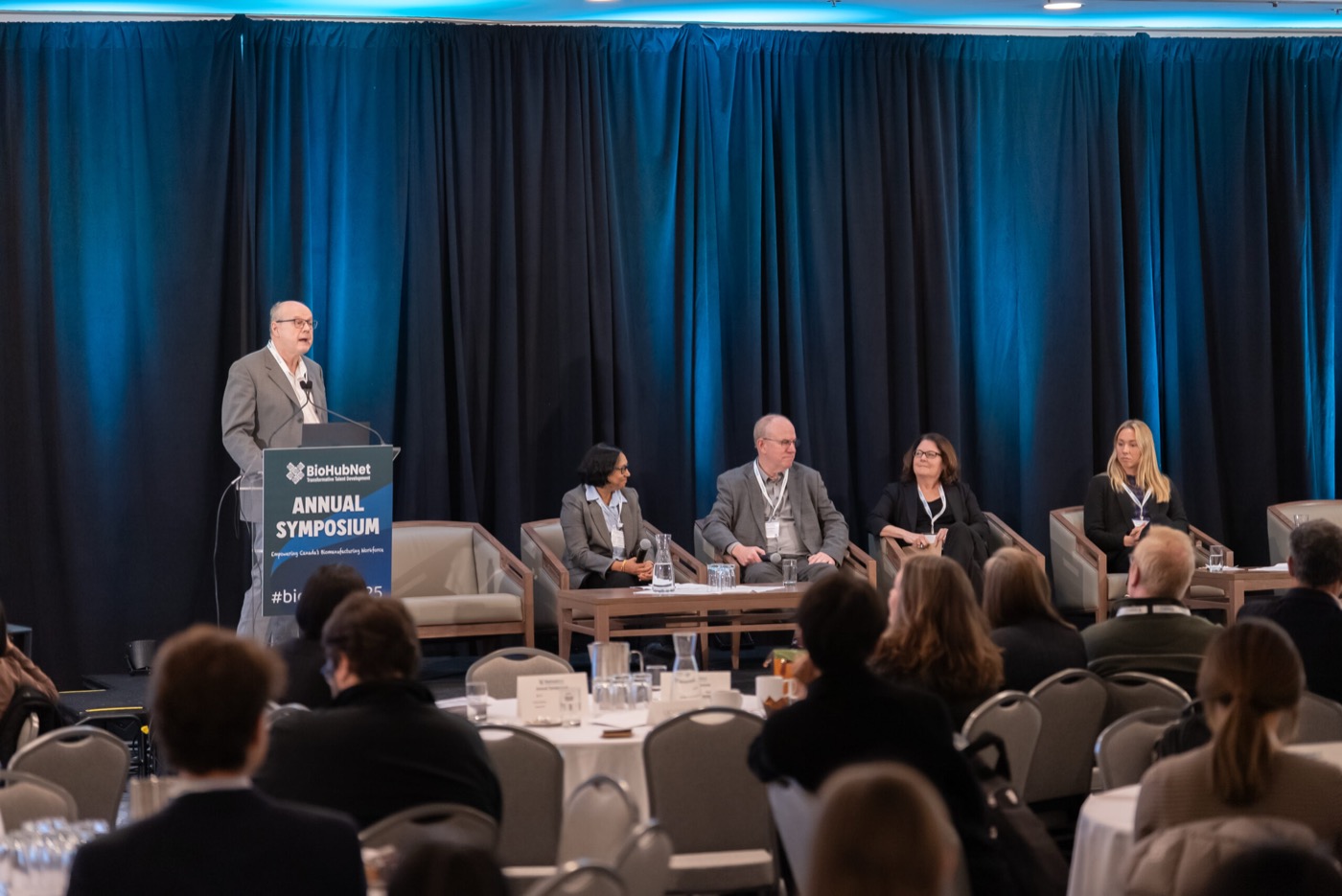 Panel discussion in front of the 2025 symposium audience