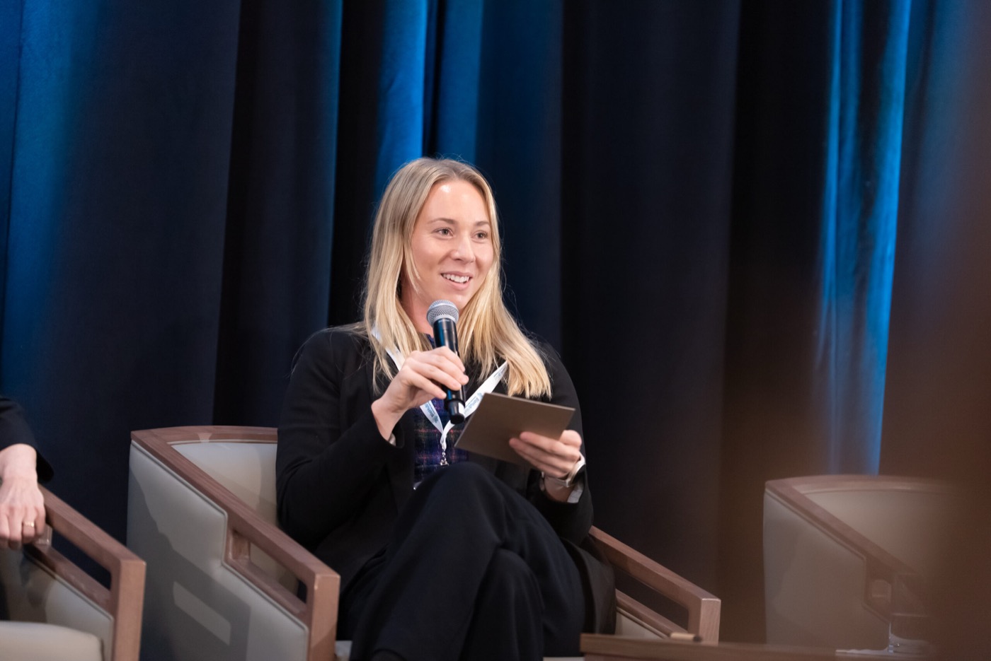Panelist speaking from a stage chair