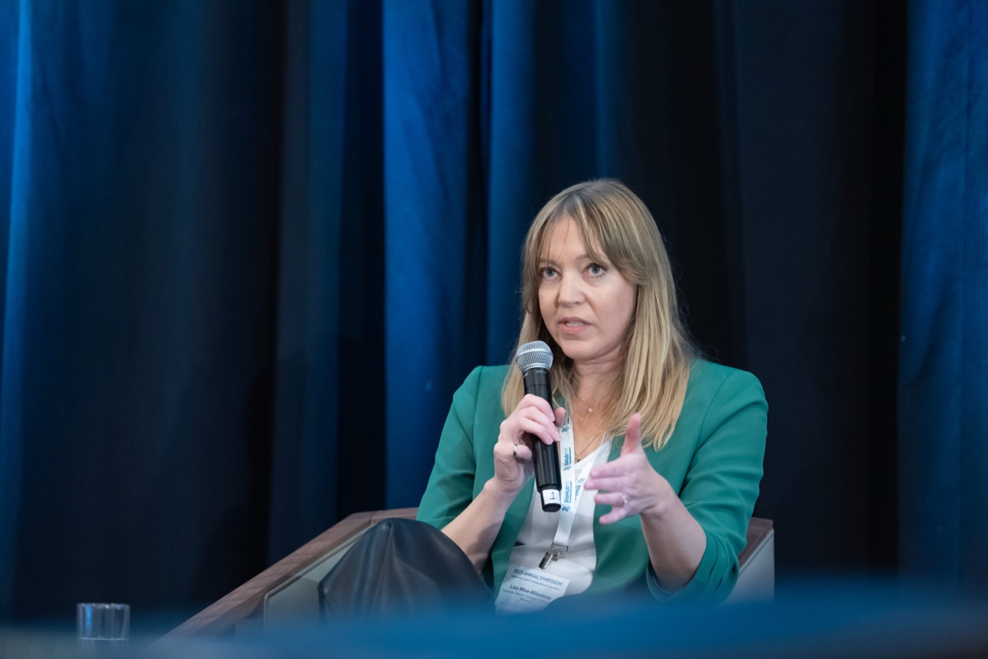 Speaker holding a microphone during the symposium