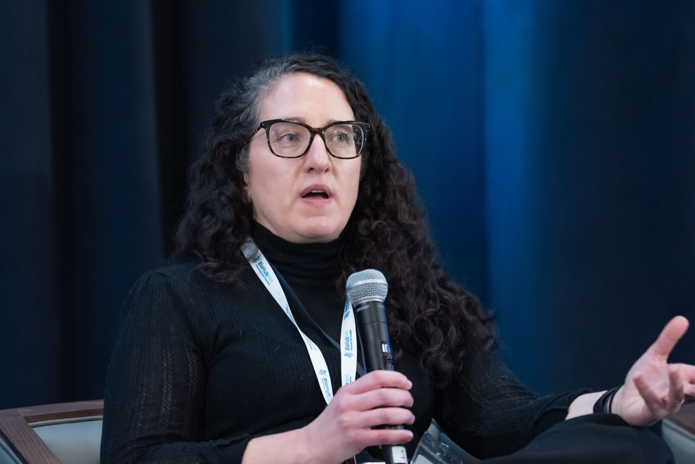 Panelist speaking into a handheld microphone