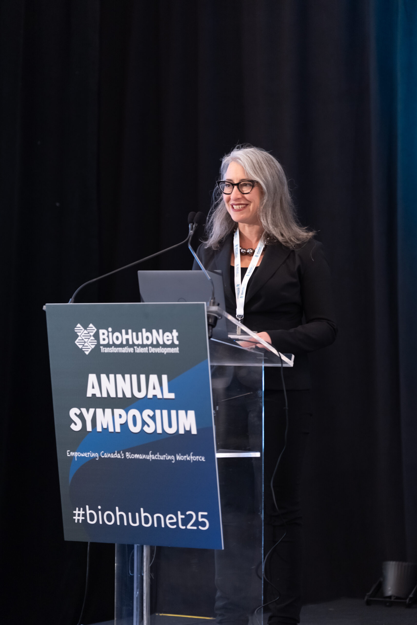 Speaker at the BioHubNet 2025 Annual Symposium podium