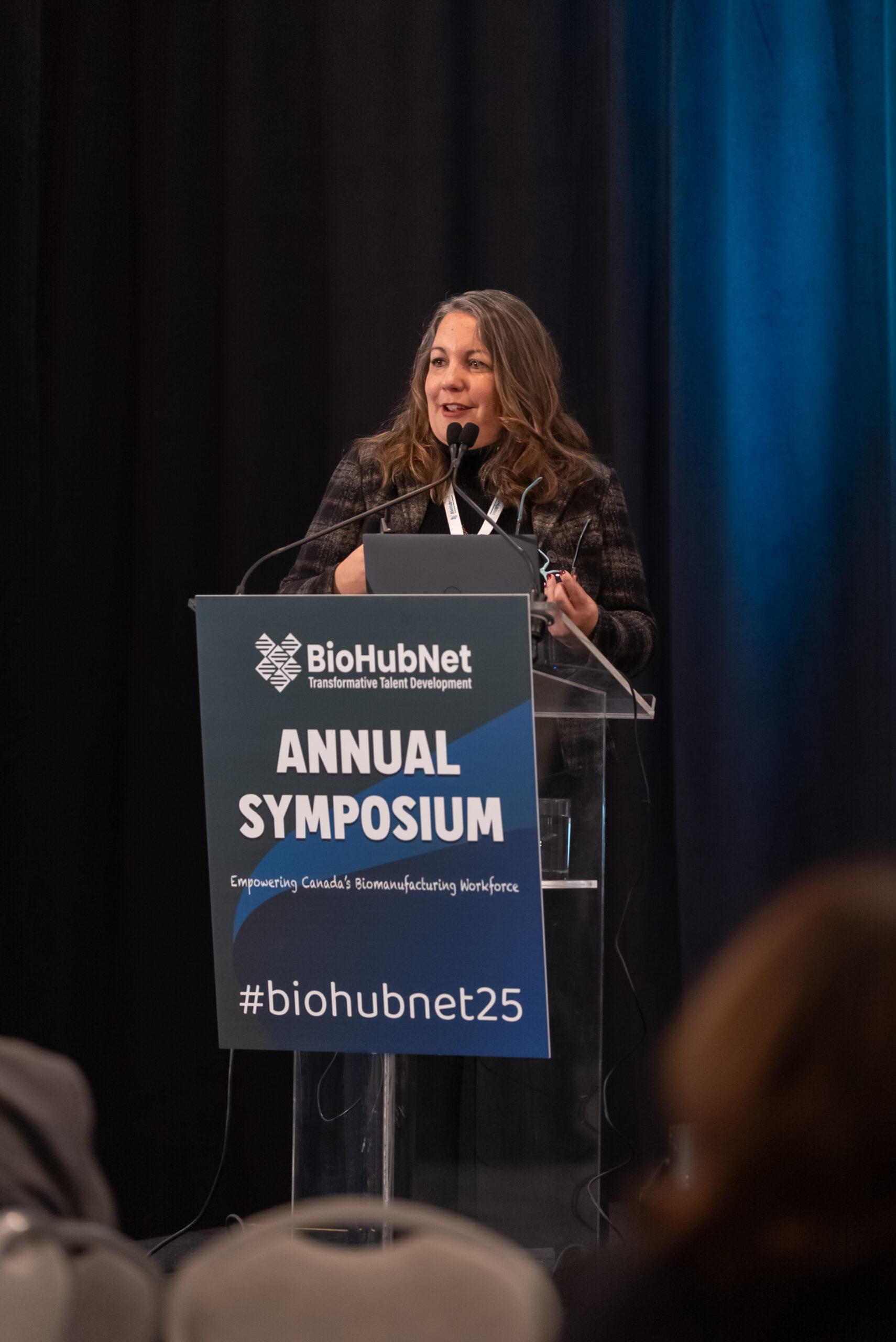 Keynote speaker at the BioHubNet 2025 symposium podium