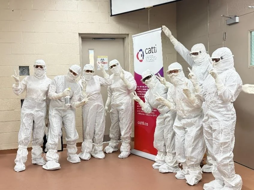 CATTI training participants wearing full cleanroom coveralls after their in-lab program