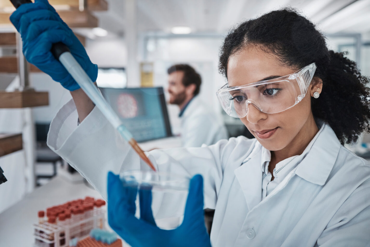 Scientist working with laboratory equipment in a biomanufacturing setting